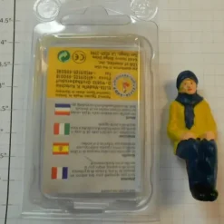 Elita Modelle 10060 Man Siting With Yellow Coat And Blue Scarf - Your Source for Gaming Essentials